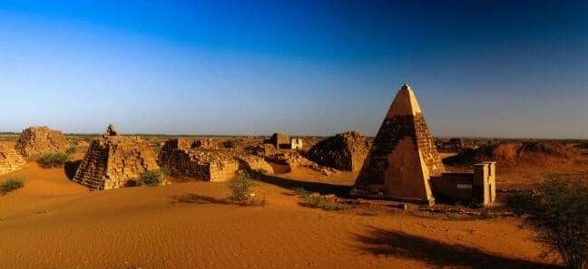 The sons of Kush. A history lesser known about ancient pharaos. Panorama of Meroe pyramids in the desert at sunset, Sudan,